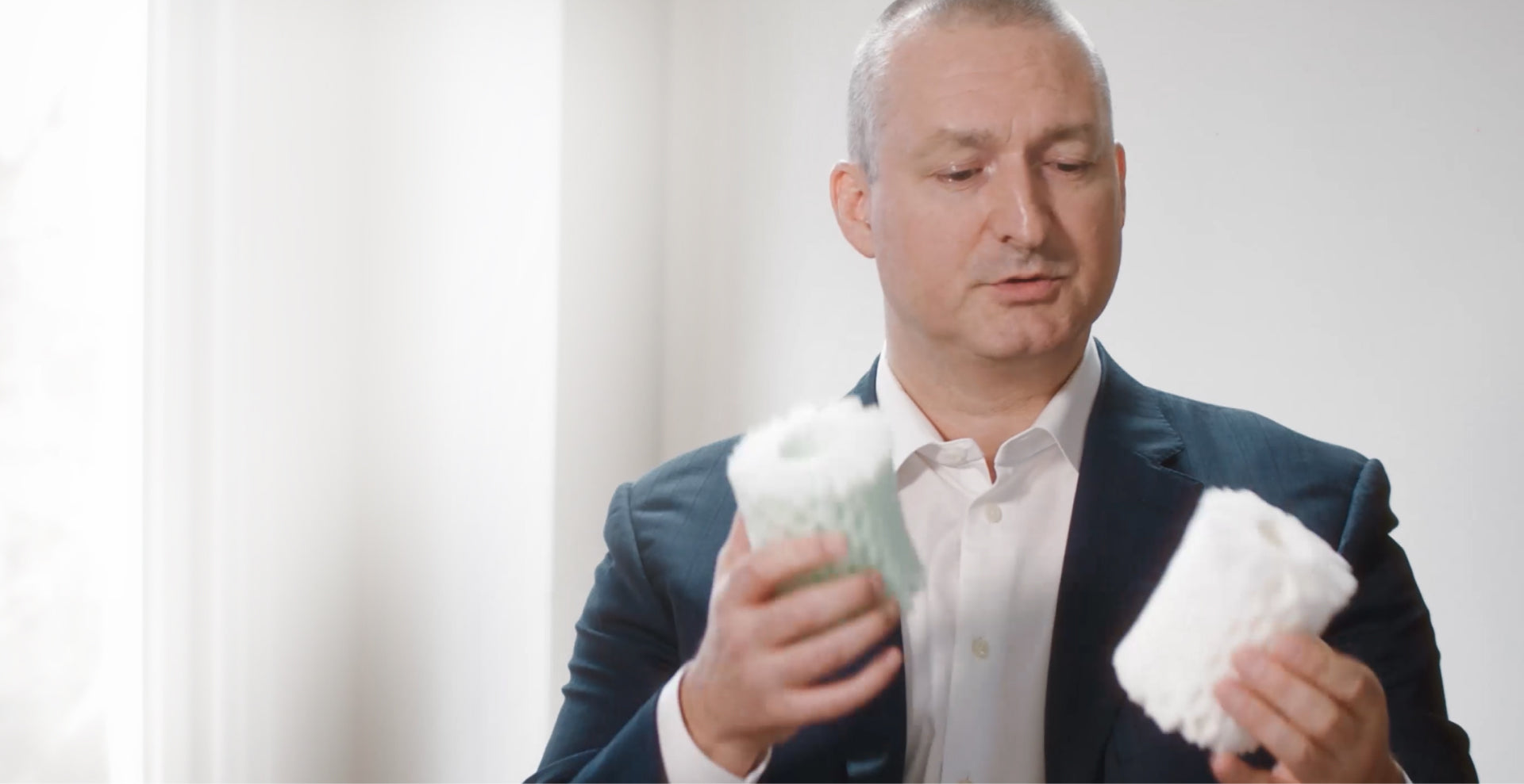 Male holding Dormero Mattress Foam